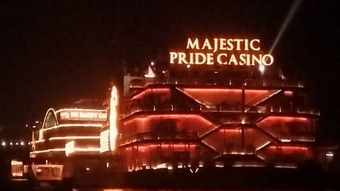 Casino ships lit up at night on the Mandovi river in Goa